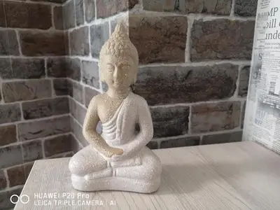 a statue of aitating person sitting on a table at Apartment SeaGarden 19 in Varna City