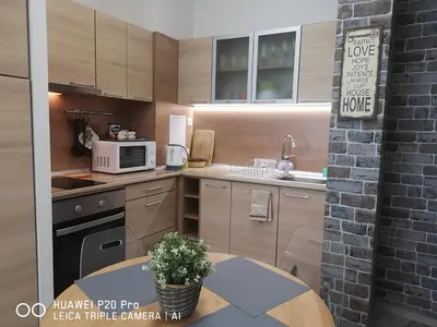 a kitchen with a table and a microwave at Apartment SeaGarden 19 in Varna City