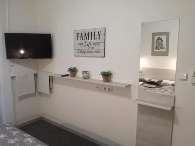 a living room with a tv on a white wall at Apartment SeaGarden 19 in Varna City