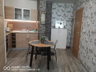 a small kitchen with a table and a refrigerator at Apartment SeaGarden 19 in Varna City