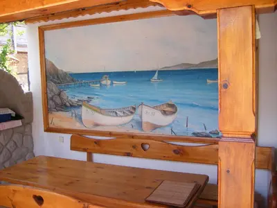 a painting of boats in the water on a wall at Dari Guest Rooms Стаи за гости Дари in Nesebar