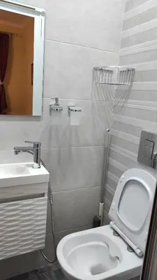 a bathroom with a white toilet and a sink at Burgas Central-Sheynovo in Burgas City