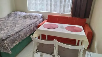 a small room with a table and a bed at Burgas Central-Sheynovo in Burgas City