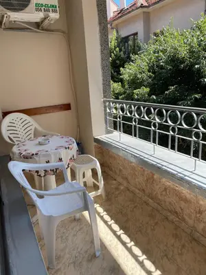 a patio with two chairs and a table on a balcony at Mariana Guest House Къща за гости Марияна in Pomorie