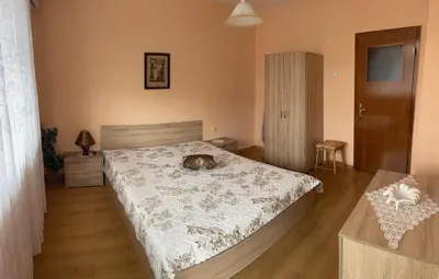 a bedroom with a dog laying on a bed at Mariana Guest House Къща за гости Марияна in Pomorie