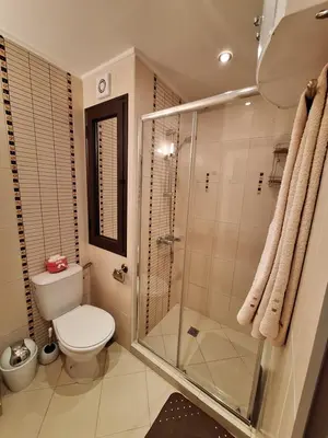a bathroom with a toilet and a glass shower at Alex Studio, Sozopol, Kavaci in Sozopol
