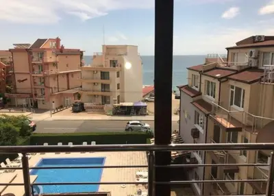a balcony with a view of the ocean and buildings at Family apartment 