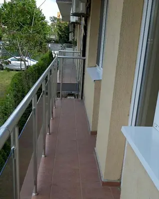 a walkway outside of a building with a balcony at Family apartment 