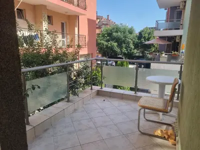a patio with a chair and a table on a balcony at Family apartment 