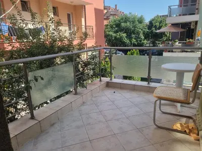 a patio with a table and a chair on a balcony at Family apartment 