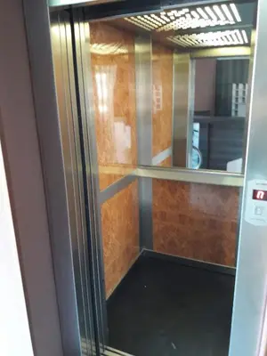 a glass door with a reflection of a room at Laguna Beach Hotel in Ravda