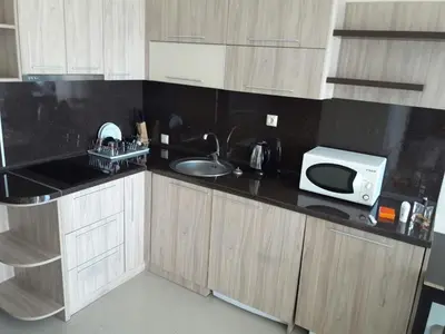 a kitchen with a sink and a microwave at Laguna Beach Hotel in Ravda