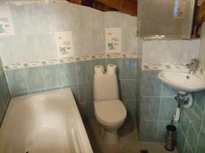 a bathroom with a toilet and a sink and a tub at Rony Hotel in Nesebar