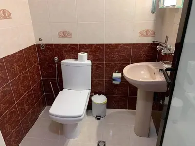 a bathroom with a toilet and a sink at Rony Hotel in Nesebar