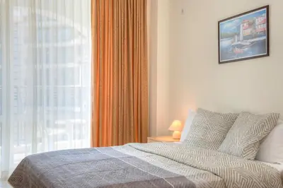 a bedroom with a bed and a large window at South Beach Vacation Apartments in Sunny Beach
