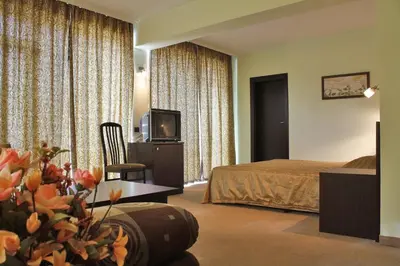 a hotel room with a bed and a television at Hotel Dukov in Obzor