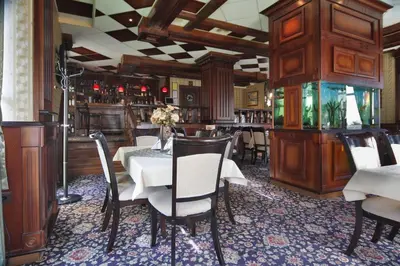 a dining room with a table and chairs at Hotel Dukov in Obzor