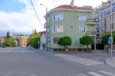 a green building on the side of a street at The Olive Green House - City Center - Free Parking in Burgas City