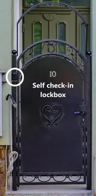a metal gate with the words self check in lockbox at The Olive Green House - City Center - Free Parking in Burgas City