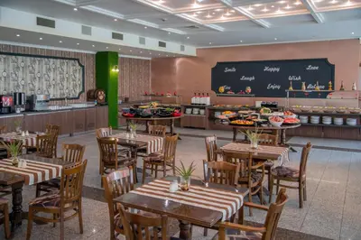 a restaurant with tables and chairs and a chalkboard at Mercury Hotel- All Inclusive in Sunny Beach