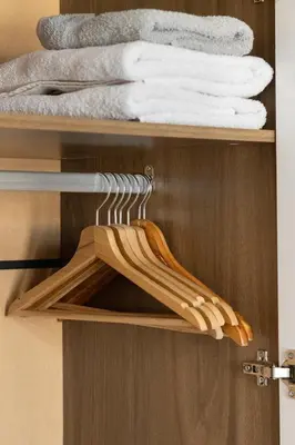 a wooden shelf with towels in a bathroom at The Captain Be my guests! by RV Apartments in Varna City