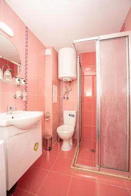 a pink bathroom with a toilet and a shower at The Captain Be my guests! by RV Apartments in Varna City
