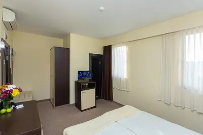 a hotel room with a bed and a television in it at Viand Hotel - All Inclusive in Sunny Beach