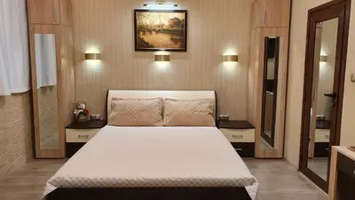 a bedroom with a white bed in a room at Deluxe Studios City Center in Burgas City