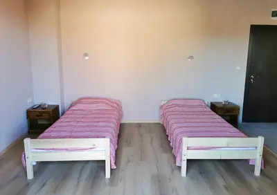 two beds with pink blankets in a room at Kazak in Obzor