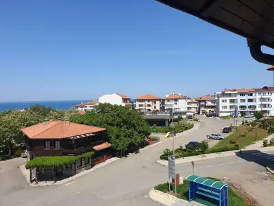 a view of a street with a building and the ocean at Hiora Apartments Vasiliko in Tsarevo