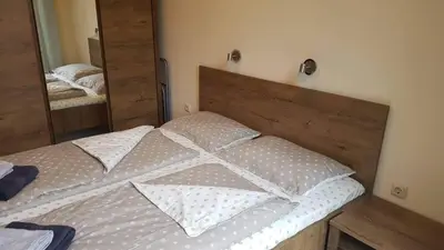 a bed in a bedroom with a large mirror at Apartman Horizont II - side sea view in Sozopol