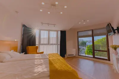 a bedroom with a large bed and a large window at B&P studios in Varna City