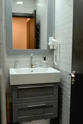 a bathroom with a white sink and a mirror at B&P studios in Varna City