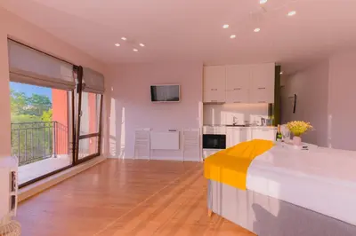 a bedroom with a large bed and a kitchen at B&P studios in Varna City