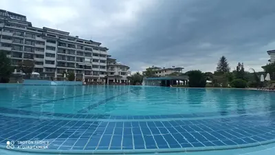 a large swimming pool with blue tiles on it at Emerald Beach Resort & Spa,studio ikat310 in Ravda