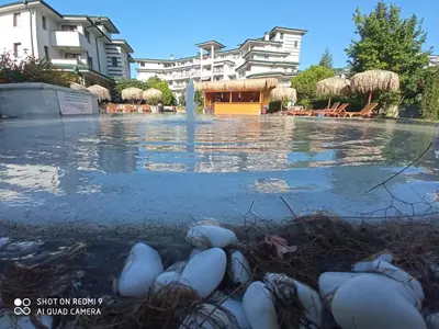 a pool with a fountain in the middle of a building at Emerald Beach Resort & Spa,studio ikat310 in Ravda