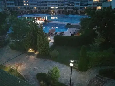 a view of a swimming pool at night at Emerald Beach Resort & Spa,studio ikat310 in Ravda