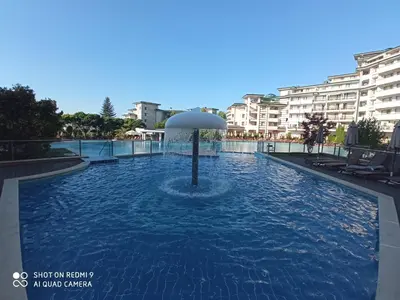 a swimming pool in the middle of a city at Emerald Beach Resort & Spa,studio ikat310 in Ravda