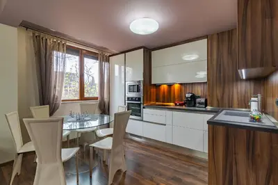 a kitchen and dining room with a table and chairs at Cosy Luxury Flat in the Centrum- 90sqm - 3 rooms. in Varna City