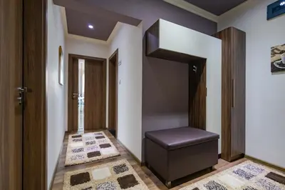 a hallway with a black stool in a house at Cosy Luxury Flat in the Centrum- 90sqm - 3 rooms. in Varna City