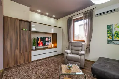 a living room with a couch and a chair at Cosy Luxury Flat in the Centrum- 90sqm - 3 rooms. in Varna City