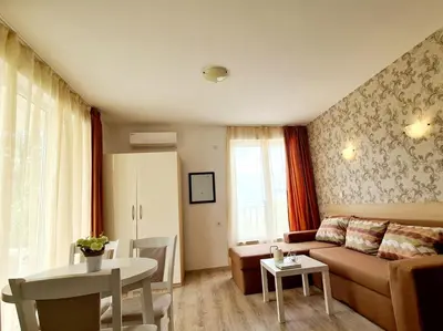 a living room with a couch and a table at MIDA Apartment in Obzor