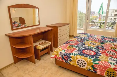a bedroom with a bed with a dresser and a mirror at Prestige City 1BD Apt with POOL near to Cacao Beach by Flаt Manаger in Sunny Beach