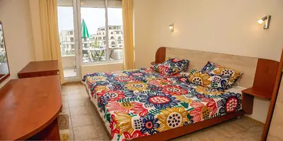 a bedroom with a bed with a colorful comforter at Prestige City 1BD Apt with POOL near to Cacao Beach by Flаt Manаger in Sunny Beach