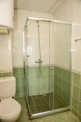 a bathroom with a toilet and a glass shower at Prestige City 1BD Apt with POOL near to Cacao Beach by Flаt Manаger in Sunny Beach