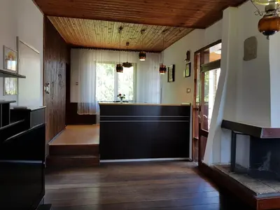 a hallway with a black door in a house at Апартамент Емилия in Sozopol