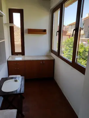 a bathroom with a sink and two windows at Апартамент Емилия in Sozopol