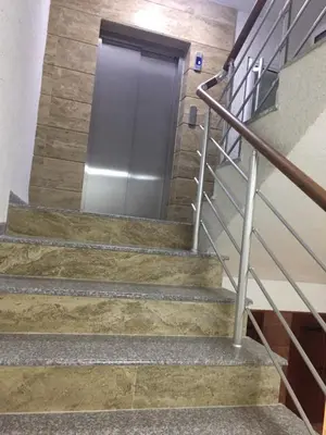 a metal door in a building with concrete stairs at Megi Luxury Apartments in Pomorie