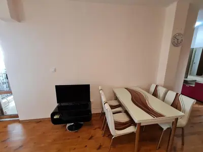 a room with a table and chairs and a piano at MitProt Panorama Bay 2 luks Apartment 173 in Sveti Vlas