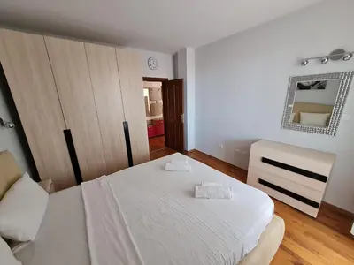 a bedroom with a white bed and a mirror at MitProt Panorama Bay 2 luks Apartment 173 in Sveti Vlas